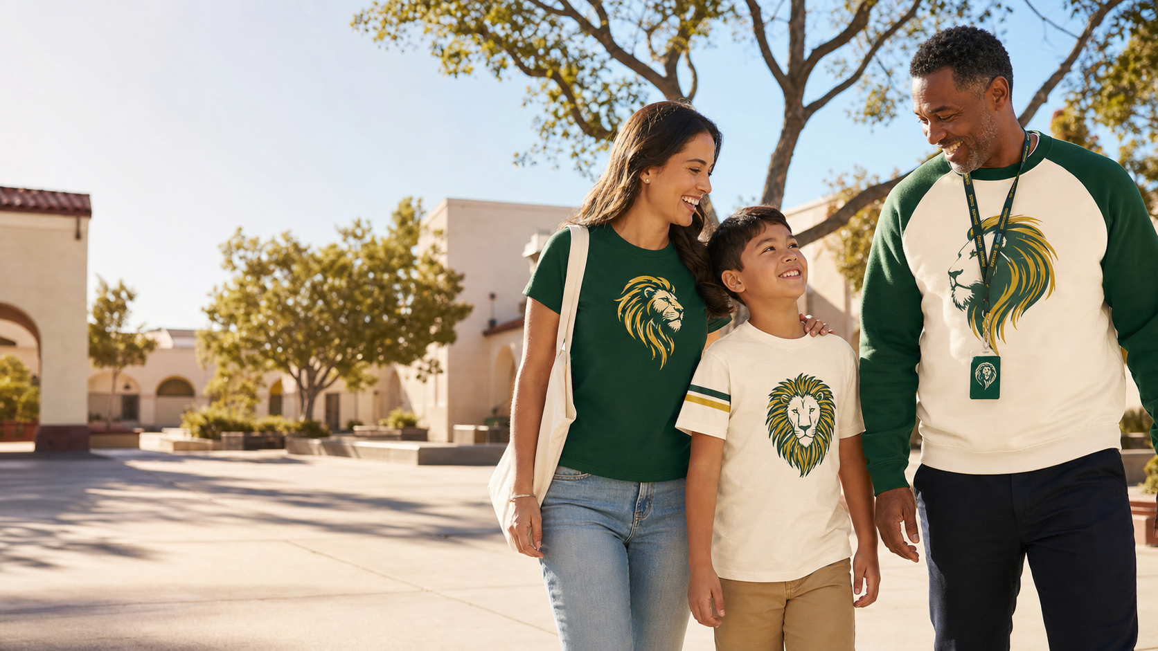 Arnold family and staff member wearing coordinated green and gold lion spirit wear on campus